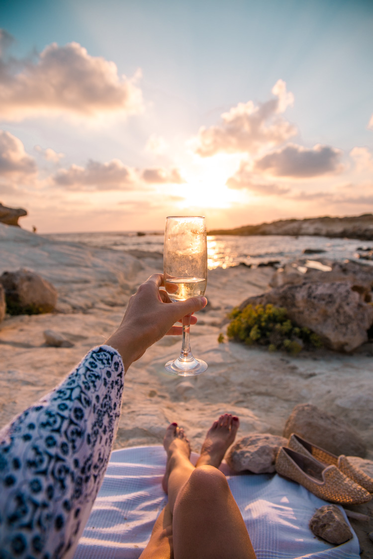 sunset views in paphos with champagne glass