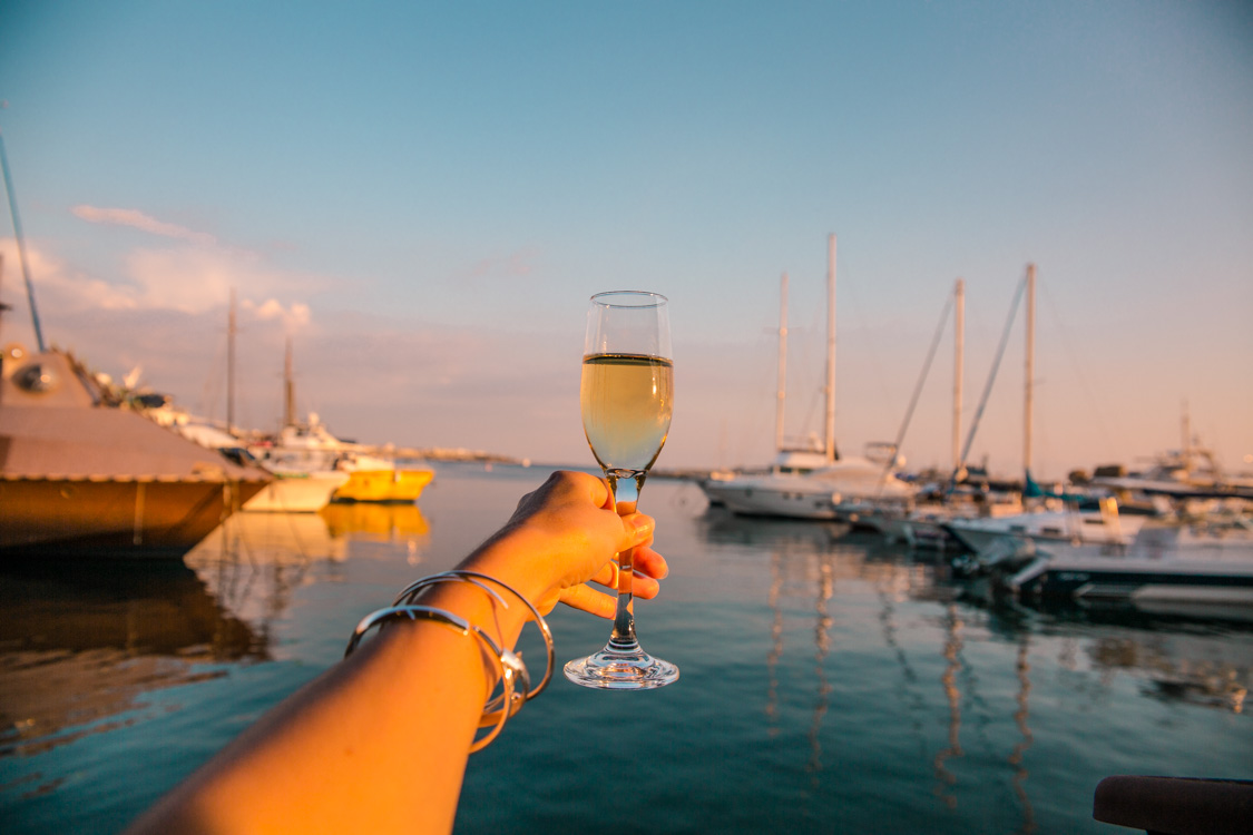 raising a glass of sparkling at Paphos Harbour restaurant, Cyprus